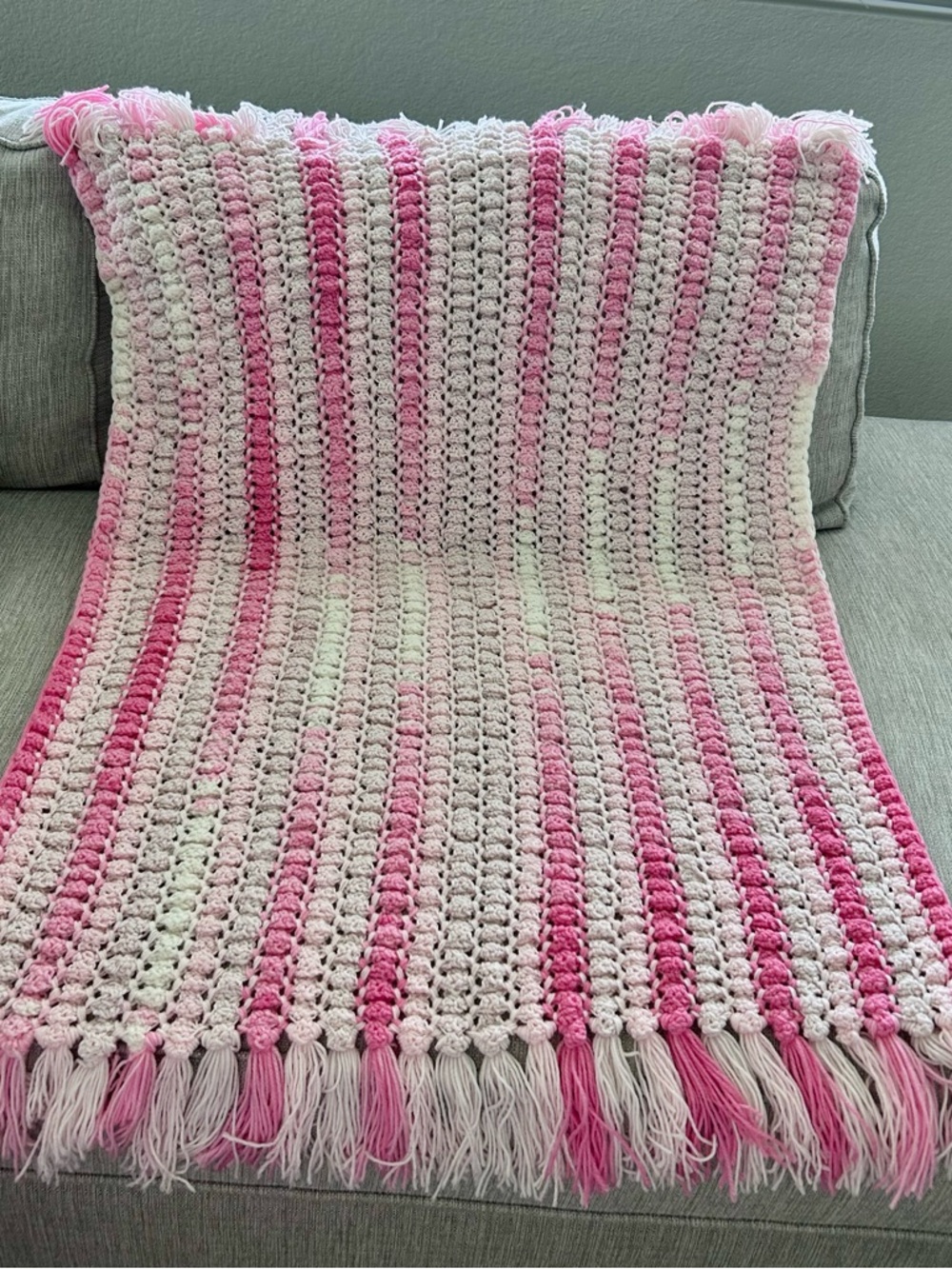 Pink and light pink crocheted baby blanket